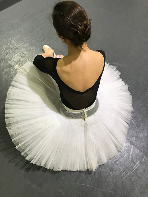 Ballet Girl adjusting her pointe shoe