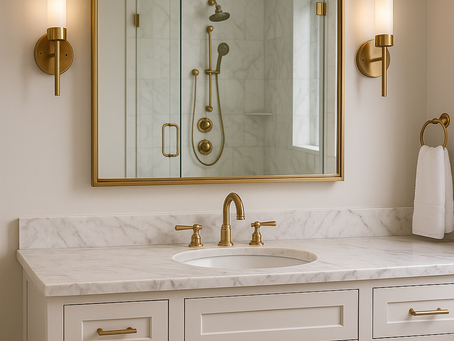 Adding statement mirrors luxury bathroom remodel with oversized brass-framed design above marble vanity.