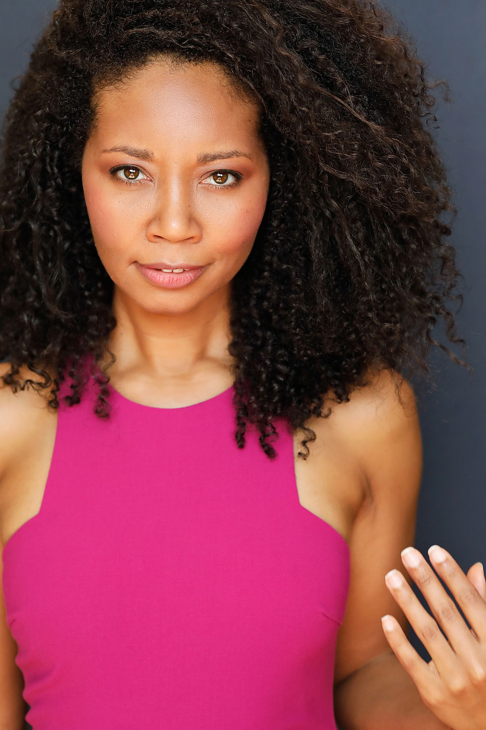 Aliza headshot in a pink sleeveless top