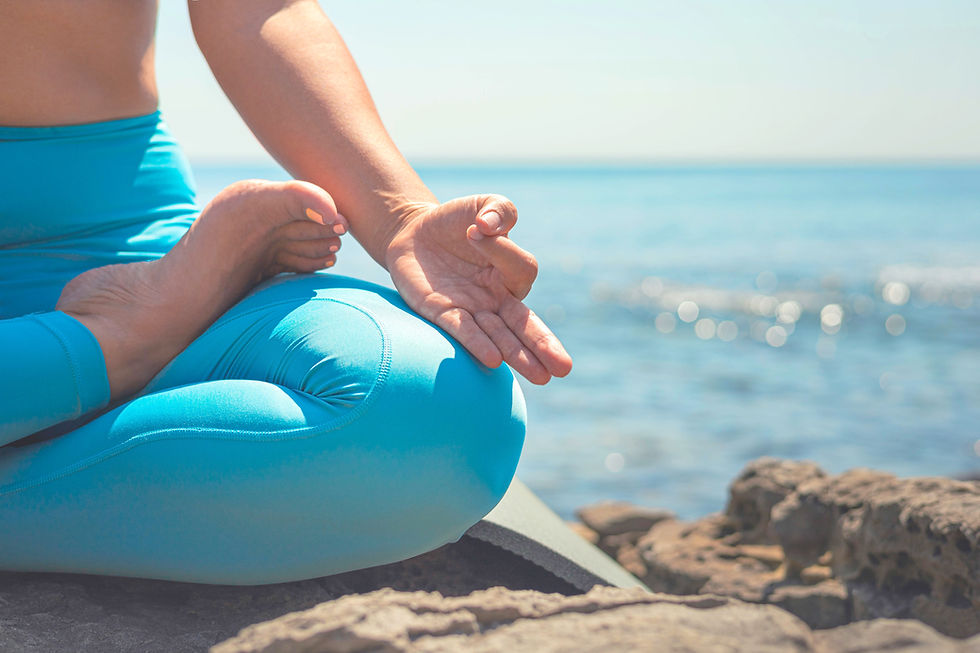 Yoga woman meditation lotus pose with hand mudra gyan gyana jnama at cliff sea beach close