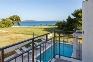A balcony overlooking a pool on a Mediterranean estate.