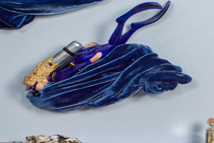 Closeup of a diver on a velvet sea background.