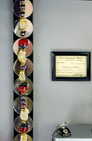 Closeup of framed license and telephone.