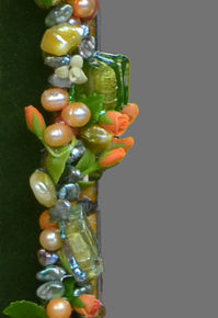 Closeup view of braided spring hued necklace.