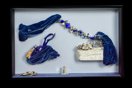 Tailor dives as machine-fed velvet turns into deep-blue ocean; lapis and pearl necklace marks the edge of imagination.