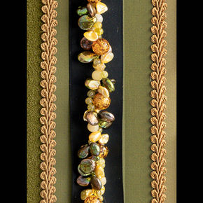 Closeup of beads and jewels with rope border.
