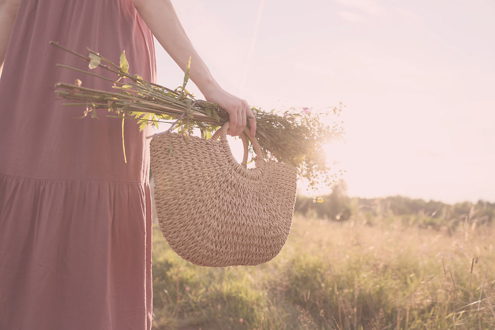 Girl carrying a basket of flowers