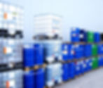 Identification labels applied to industrial IBC containers and oil drums.