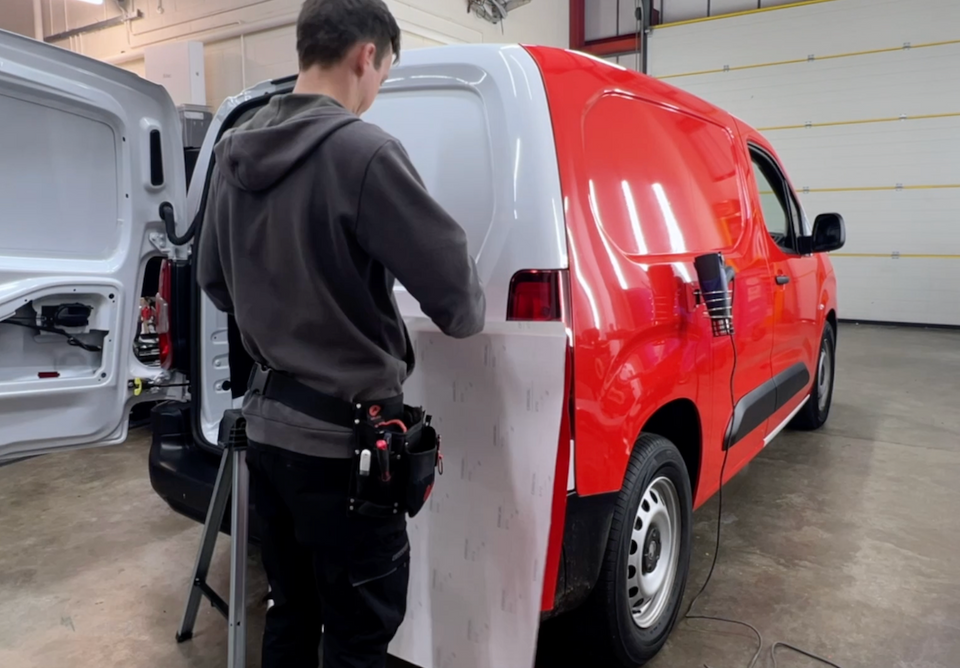 Young Bros Vauxhall Combo with a complete red van wrap and branded vehicle graphics.