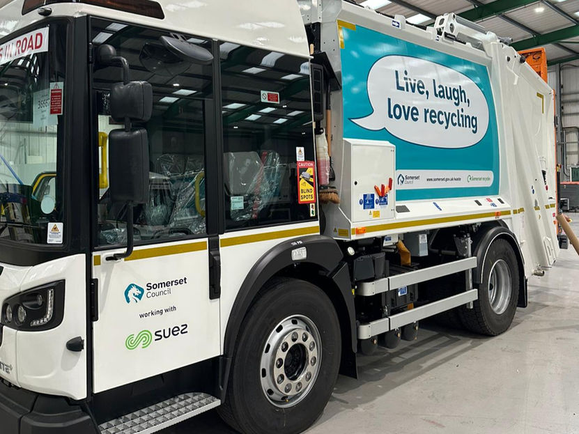 Fleet graphics installation for Somerset waste contract vehicles, with new RCVs fitted at Dennis Eagle using simplified, modern recycling messaging.