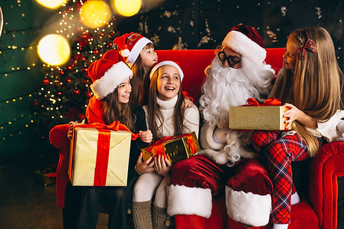 group-kids-sitting-with-santa-presents-christmas-eve.jpg
