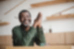 smiling mature african american man sitting in cafe.jpg