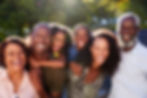 Outdoor Portrait Of Multi-Generation Family In Garden At Home Against Flaring Sun.jpg