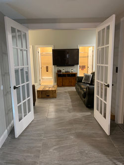 ENTRYWAY TO GREAT ROOM UPSTAIRS AND STAIRWAY UPSTAIRS