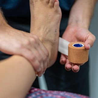 Physiotherapist doing ankle taping
