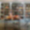 Bookshop interior: shelves filled with various books, display table with new releases