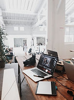 laptops spread out across a work table
