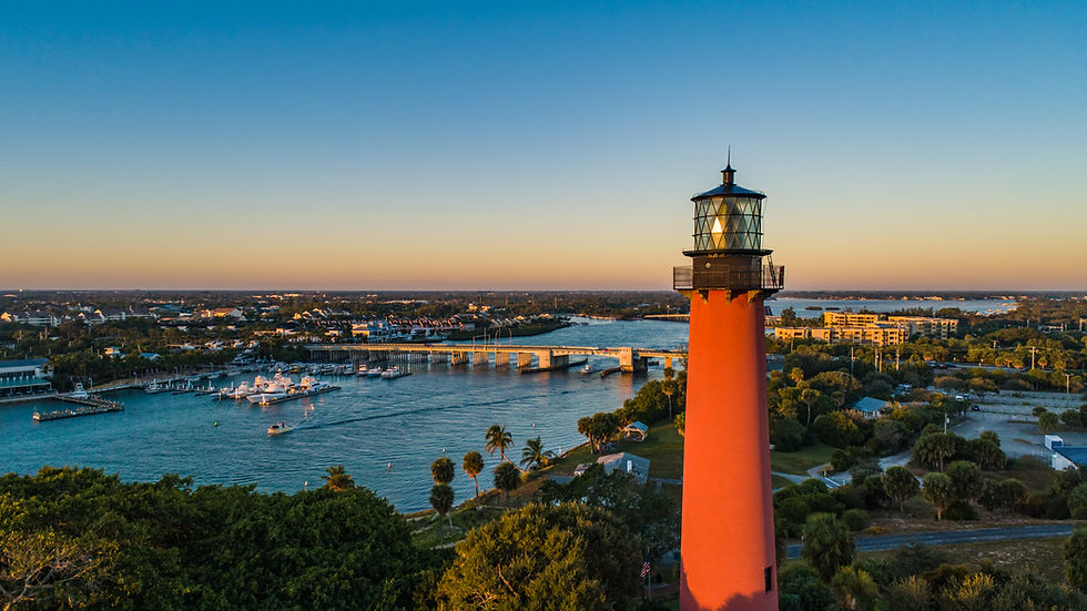 image of the jupiter Florida lighthouse with the water, bridge, and boats in the background