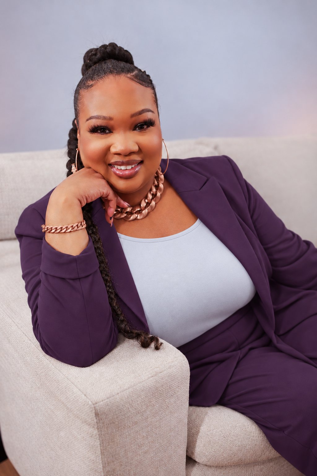 Ariel Salomé seated, chin resting on her hand, smiling