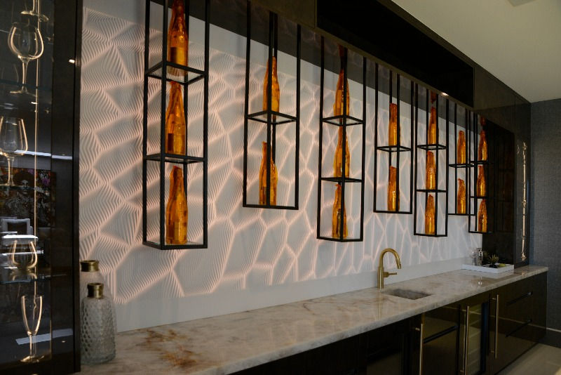 Lush high gloss wall cabinetry in solid black for modern bar