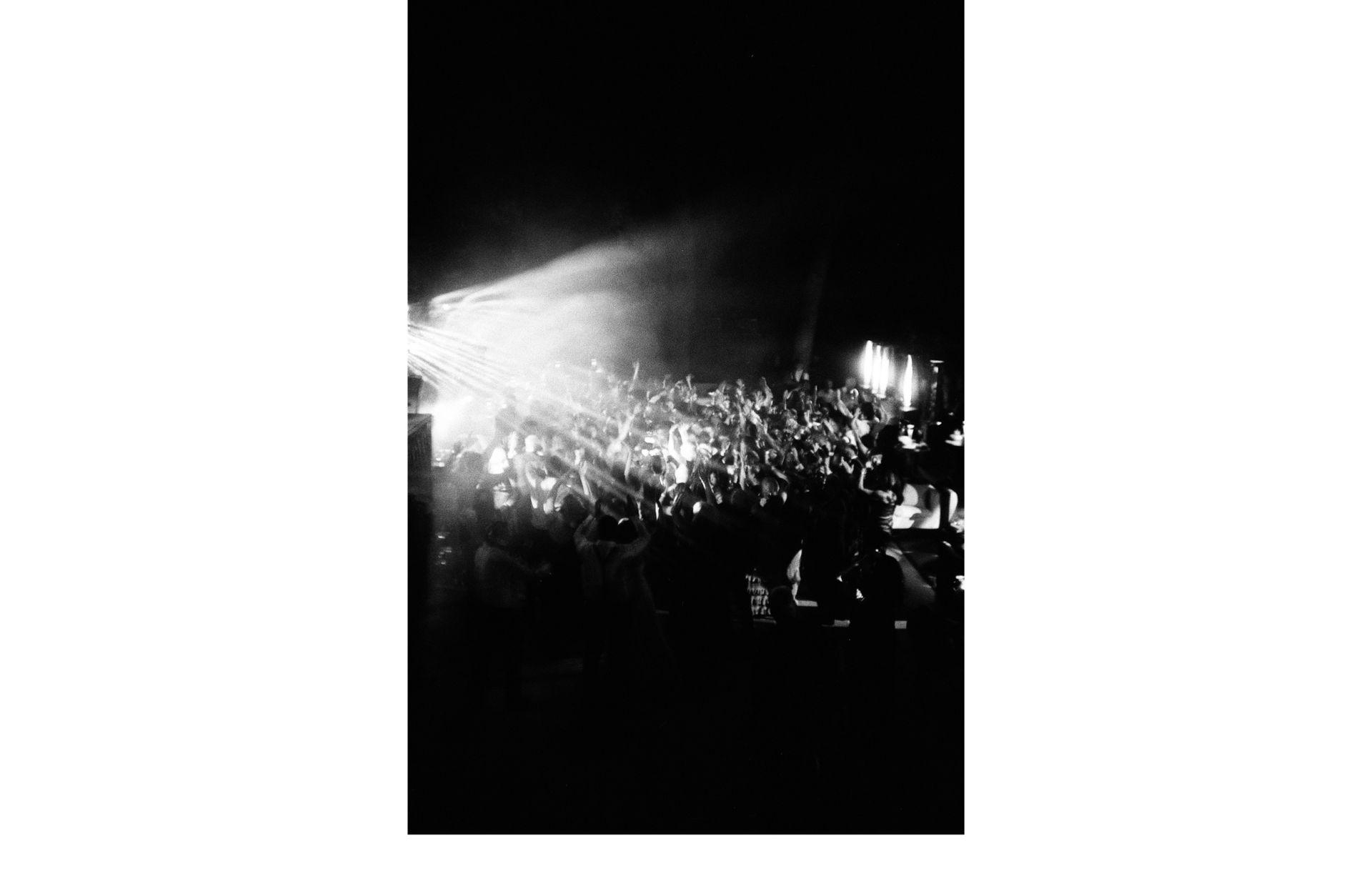 Crowded wedding after party at Castiglion del Bosco in Tuscany with dramatic lighting, DJ performance, and packed dance floor photographed by CALENROSE destination wedding photographers