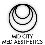 Clean, professional medical spa treatment room with neutral tones at Mid City Med Aesthetics in Omaha