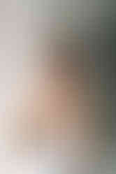 New Orleans bride putting on earrings