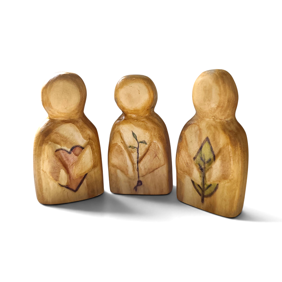Guardian figures – three carved shapes with heart–sprout–leaf symbols.