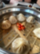 soup dumplings in a steamer basket