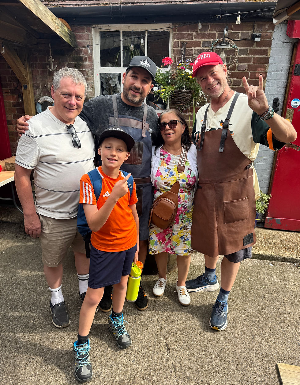Eye-level view of DJBBQ with Chris from OriginBBQ and his family