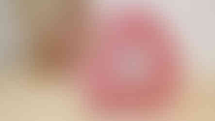 A red quilted gingham heart shaped vanity bag (train case or makeup bag) with a handle and a zipped inner pocket.