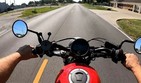 a rider's view over the handebars of riding a mototrcycle