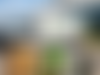 Cannabis delivery van outside a modern warehouse with packaged products in the foreground.