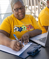Zina at REACH-FEEDMORE table.jpeg