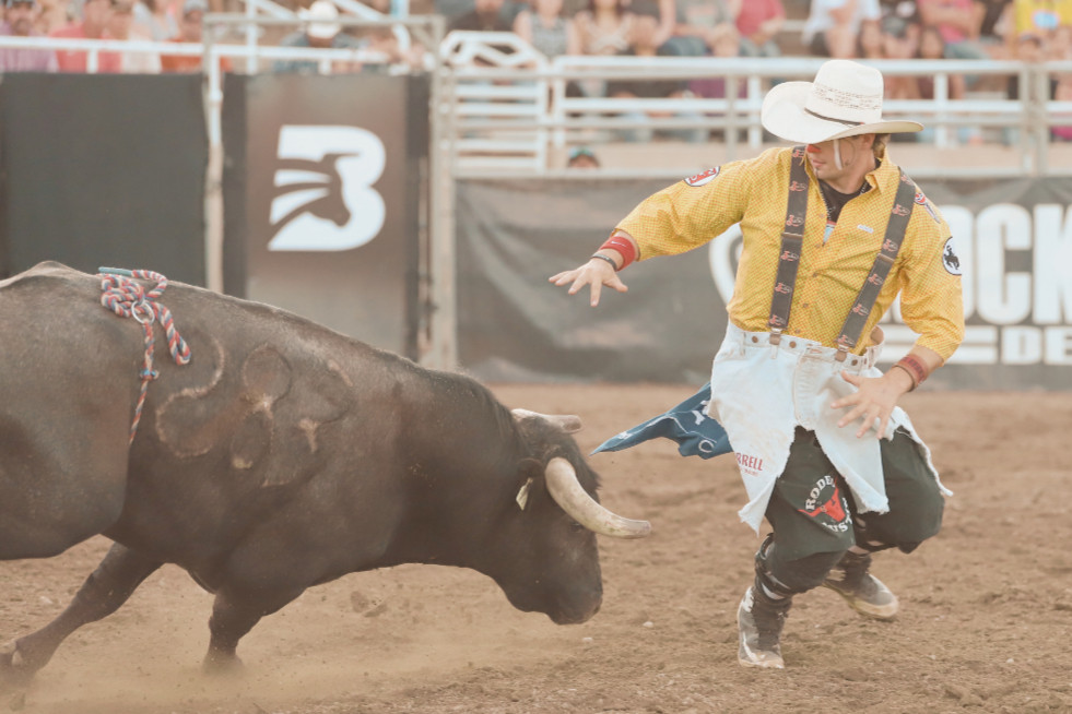 MAN RUNNING FROM BULL