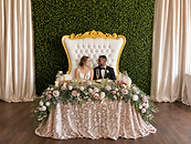 Blush and gold wedding sweetheart table with floral décor and throne seating