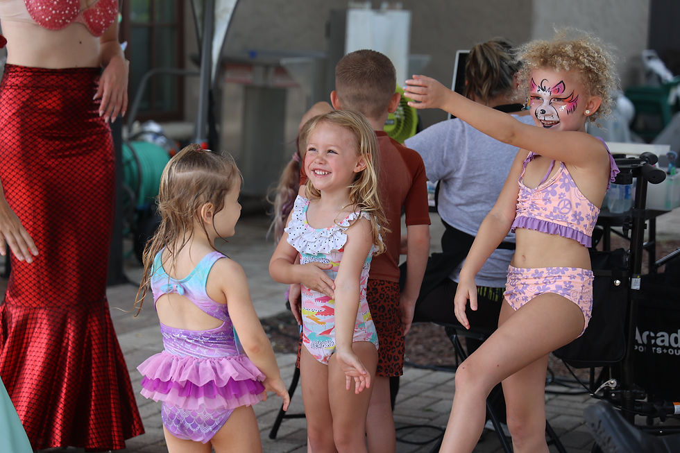A group of beautiful girls joyfully dance in sync during the mermaid-themed party. Their vibrant outfits, inspired by the ocean's colors, shimmer and twirl as they move gracefully to the music. Their beaming smiles capture the excitement and enchantment of the mermaid dance party.