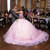 Quinceañera dancing in a pink ball gown at her celebration