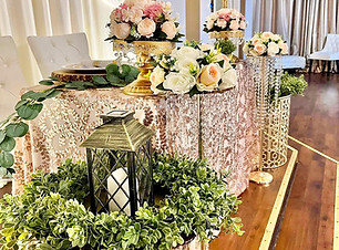Elegant sweethearts table with florals, lanterns and greenery