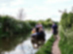 Friends enjoying a narrowboat day trip on the Grand Union Canal near Tring, cruising through peaceful Hertfordshire countryside.