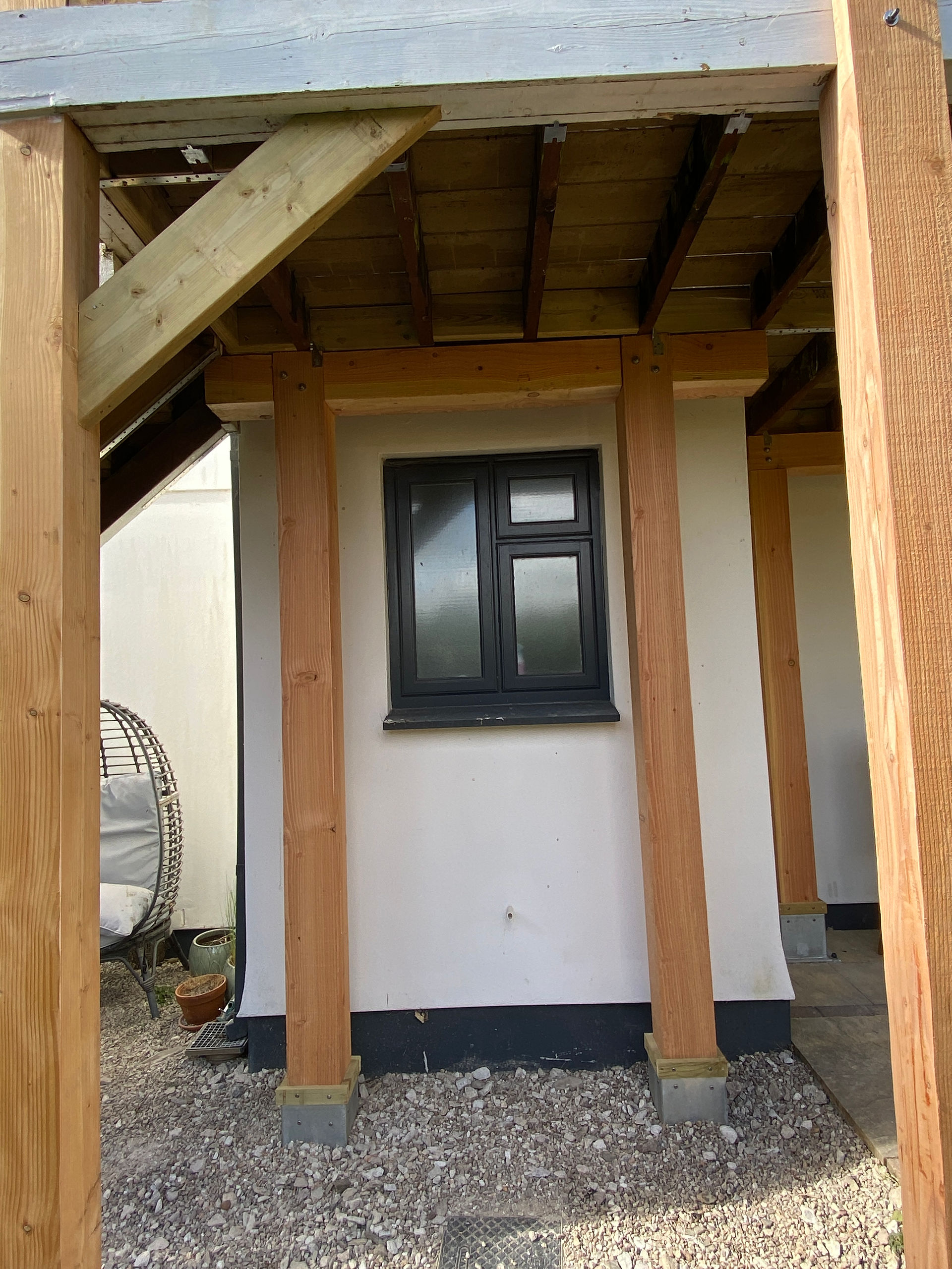 Douglas fir structural posts and diagonal bracing supporting a repaired timber balcony and decking area in Padstow Cornwall by a builder near Wadebridge