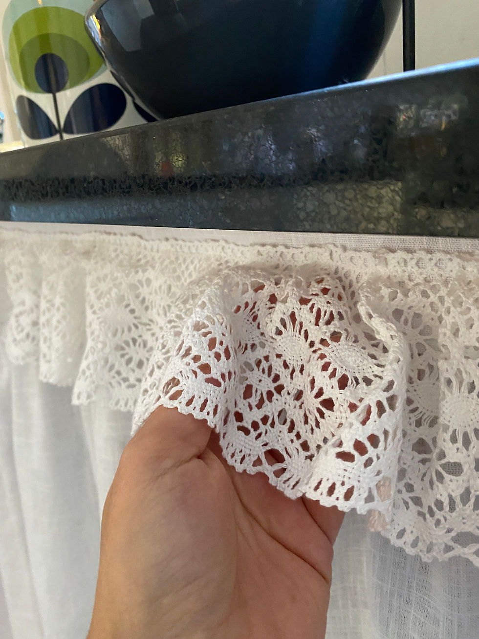 white skirt with lace frill under black counter