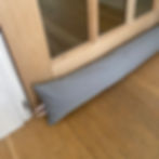 Silver Waterproof draught excluder on panelled wooden door