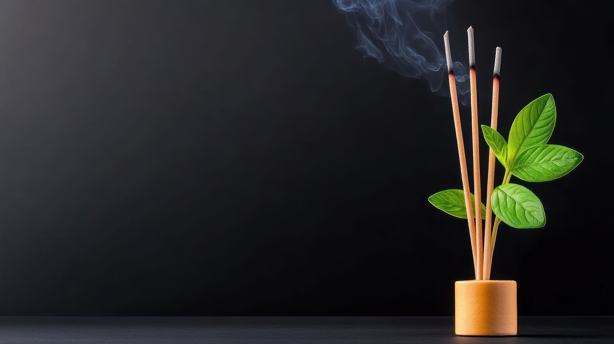 incense-sticks-emitting-smoke-beside-green-leaves-holder.jpg