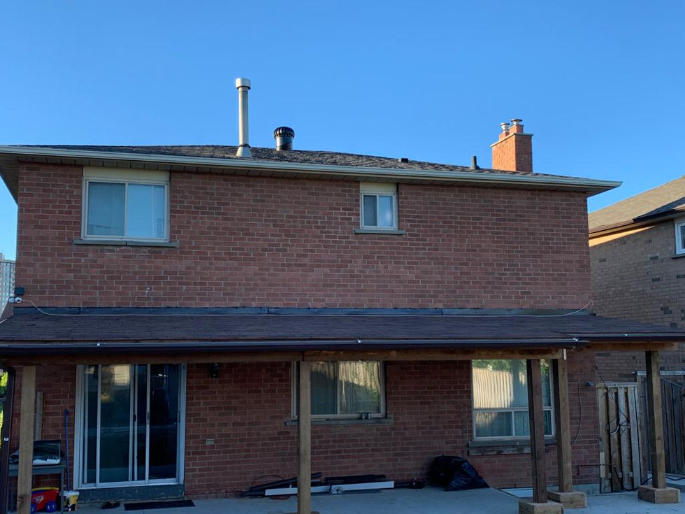 Covered patio structure with shingle roof built by Aria Custom Decks in Guelph