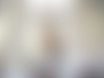 A woman stretching on her bed in soft morning light, representing the renewal and calm that come from slowing down and resting well.