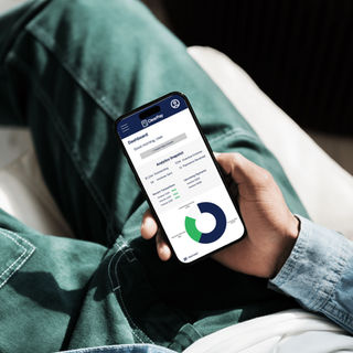 Person holding phone displaying financial graph.