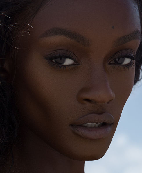 Natural Light Beauty Photography of a black melanin model with natural makeup by Los Angeles cosmetic portrait photographer.