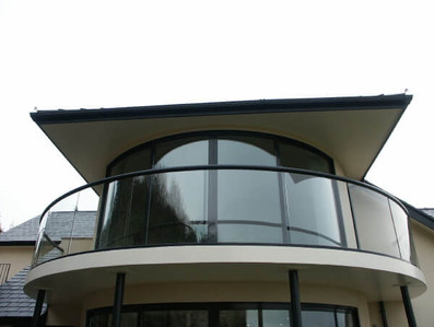 beautiful curved glass balcoiny and curved sliding doors north wales.jpg