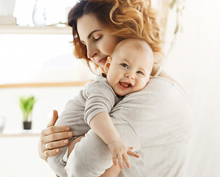 happy-young-mom-holds-precious-little-child-gently-hugging-his-little-body-kid-laughing-jo